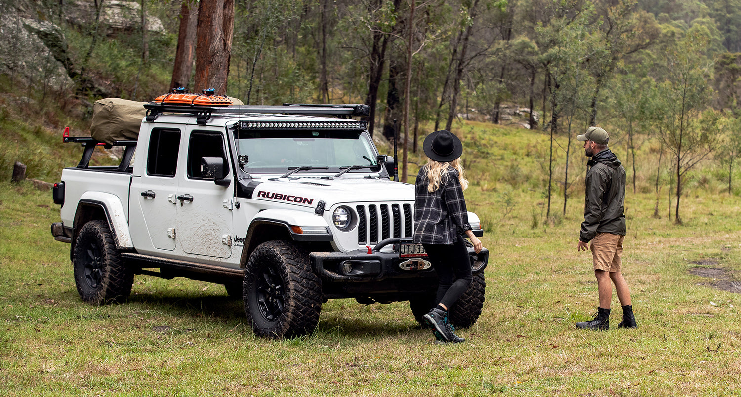 2 Personen die sich den Jeep Gladiator mit Rhino Rack Zubehör ansehen.